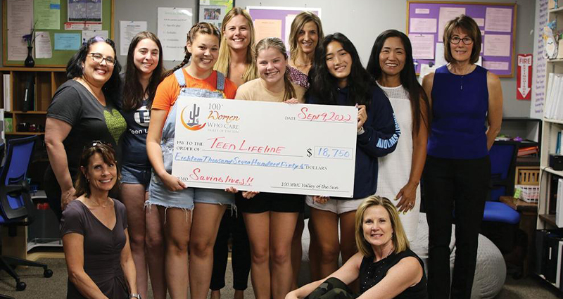 Photo of 100+ Women Who Care Valley of the Sun presenting a check for $18,750 to the teen volunteers and staff members of Teen Lifeline.