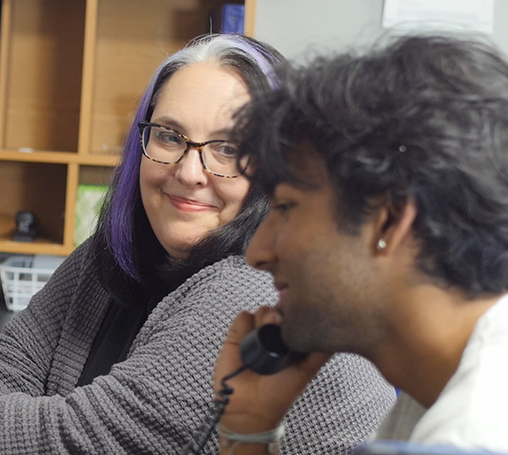 Photo of Teen Lifeline Clinical Director Nikki Kontz and a teen volunteer on the hotline.