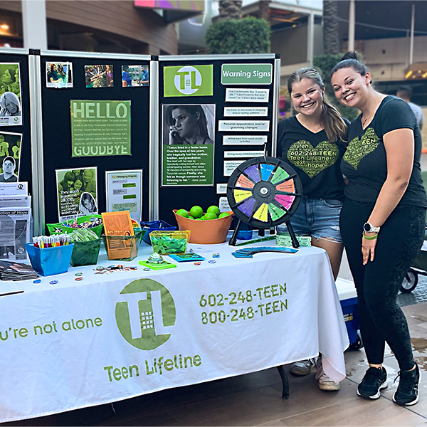 Photo of Teen Lifeline teen peer counselors at a resource booth at the 2022 Teen Suicide Prevention Month Rally.