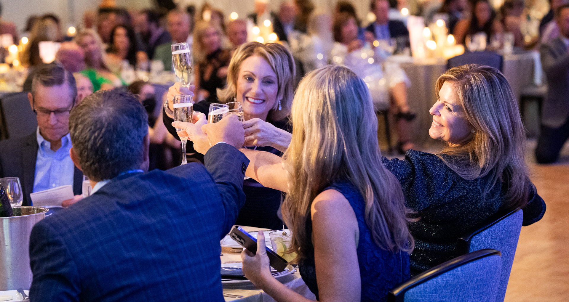 Photo of a table toasting at the 2023 Connections of Hope Gala.