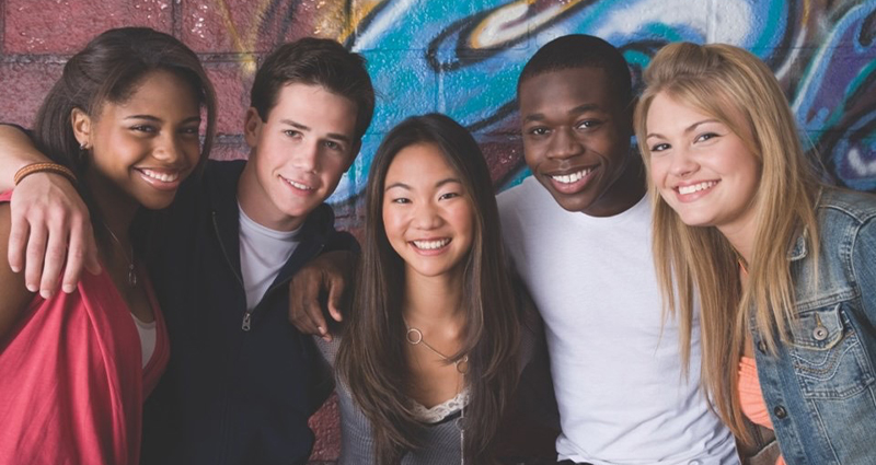 Stock photo of a group of smiling teens.